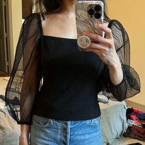 Socialite black cropped top with mesh sleeves. Size XS.